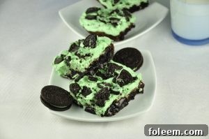Sinful Triple Layer Fudge Mint Oreo Brownies are rich and loaded with chocolate goodness. Everyone will go crazy over this dessert recipe and it's festive and fun!