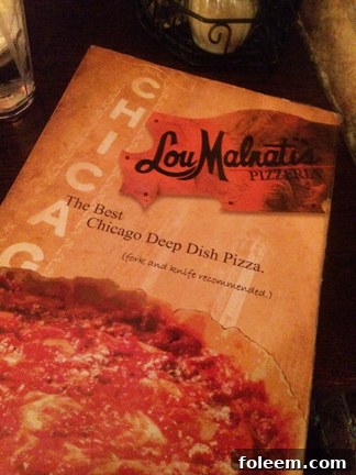 Lou Malnati's Pizzeria review of deep dish pizza in Chicago, highlighting its famous flaky butter crust.