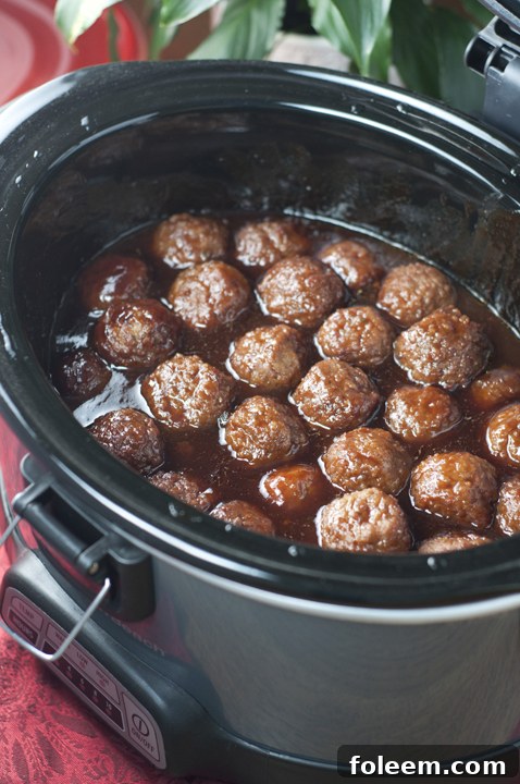 Crock Pot Grape Jelly BBQ Cocktail Meatballs are an awesome recipe for holiday entertaining, Super Bowl party, or pot luck made right in the slow cooker. They are so simple to make and extremely crowd-pleasing!