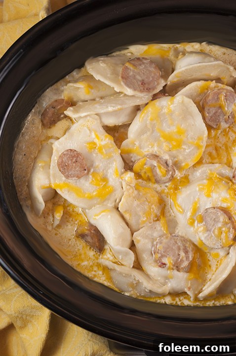 Crock Pot Sausage Pierogi Casserole recipe is a delicious and comforting dish made with chicken sausage and a creamy cheese sauce. Great for potlucks or a weeknight dinner that cooks right in the slow cooker!