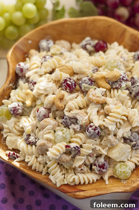 Creamy Cashew Chicken Rotini Salad loaded with tender chicken, crunchy cashews, sweet fruit, and fresh vegetables – perfect for any occasion!