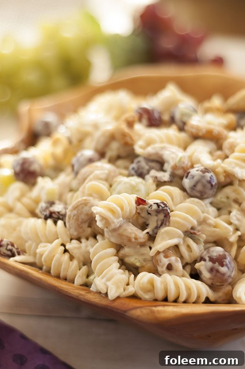 Fruity Cashew Chicken Rotini Salad loaded with chicken, cashews, fruit and veggies is my new favorite pasta salad, perfect for dinner, a summer BBQ, or any potluck gathering!