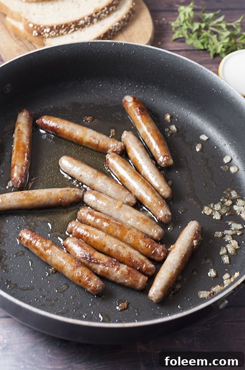Using a non-stick skillet to perfectly brown the pork sausage and sauté onions for the delicious Sausage, Egg, and Cheese Scramble.