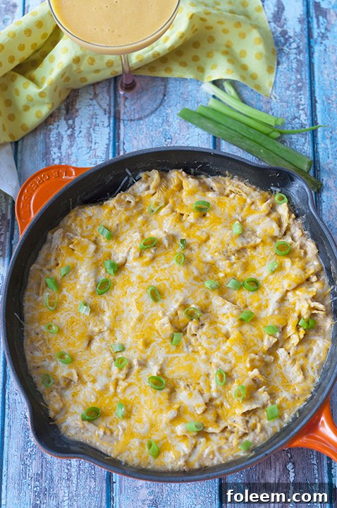 Delicious One Pan Sour Cream Chicken Enchilada Skillet with melted cheese and fresh cilantro, ready to serve.