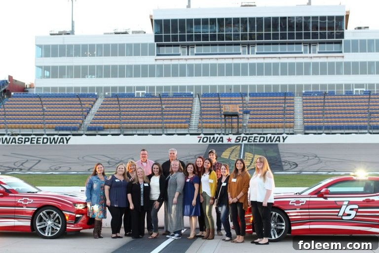 Group photo of the Iowa Corn Tour participants at the Iowa Speedway, commemorating their visit.