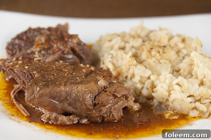 Tender, fall-apart, juicy Slow Cooker Italian Pot Roast recipe is packed with flavor and an easy weeknight dinner. It's fancy enough to serve to dinner guests for a holiday meal and the crock pot does all the work!