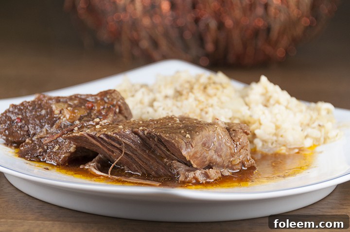 Tender, fall-apart, juicy Slow Cooker Italian Pot Roast recipe is packed with flavor and an easy weeknight meal. It's fancy enough to serve to dinner guests for a party or Christmas dinner and the crock pot does all the cooking for you!