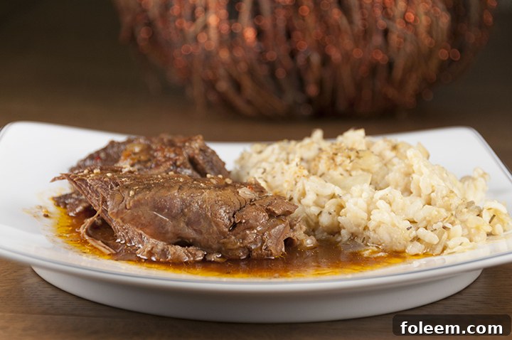 Tender, fall-apart, juicy Slow Cooker Italian Pot Roast recipe is packed with flavor and an easy weeknight meal. It's fancy enough to serve to dinner guests for a dinner party or Christmas dinner and the crock pot does all the cooking for you!