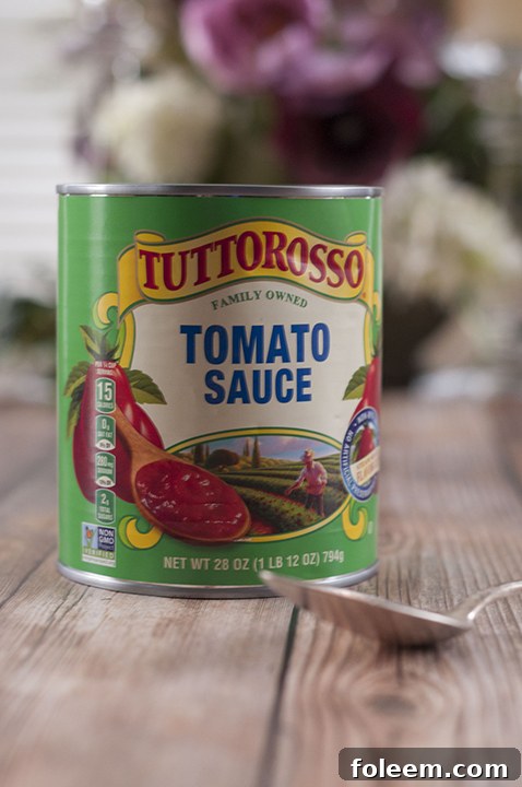Close-up of a can of Tuttorosso tomato sauce, showcasing premium quality ingredients.