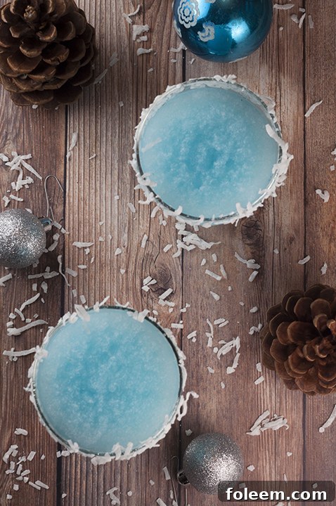 Blue Christmas Coconut Cocktail recipe is the best Christmas alcoholic drink and is sure to put a smile on everyone's faces! This is perfect for serving at a party and you can make a large batch!