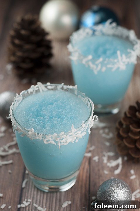 Blue Christmas Coconut Cocktail recipe is the best boozy Christmas drink and is sure to put a smile on everyone's faces! This is perfect for serving at a party and you can make a huge batch of it.