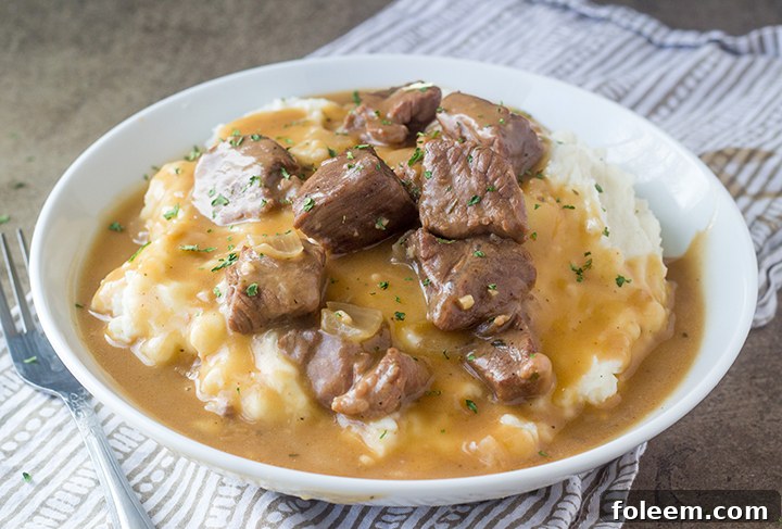 Crock Pot Beef Tips and Gravy cooking in the slow cooker, a perfect choice for an easy yet elegant meal.