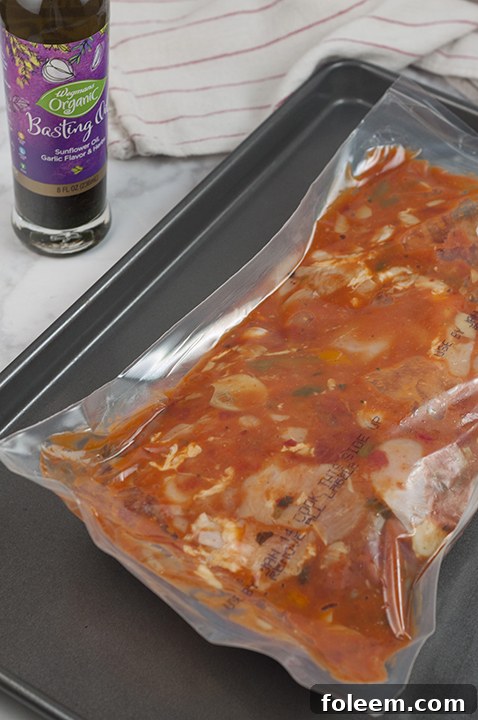 Wegmans Chicken Cacciatore oven-ready meal placed on a baking pan, poised to go into the oven.