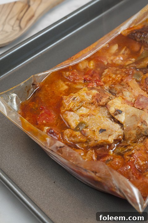 Taking the fully cooked and aromatic Chicken Cacciatore out of the oven, ready to serve.