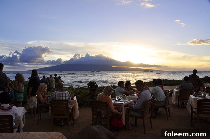 Hula dancers performing elegantly at sunset during the Feast at Lele Luau in Maui, Hawaii, creating a magical atmosphere.
