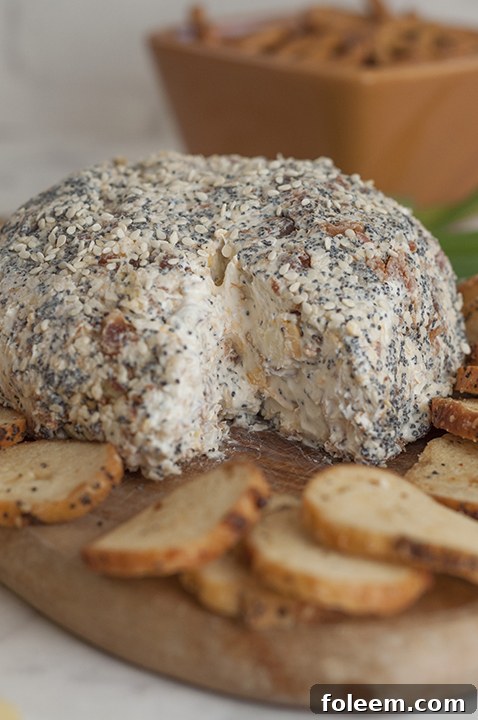 Delicious Everything Bagel Cheese Ball served with bagel chips on a wooden board, perfect for parties and gatherings.