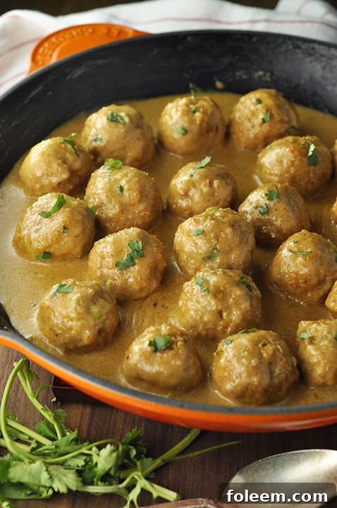 Easy Skinny Thai Peanut Chicken Meatballs dinner recipe served over rice with an abundance of sweet, and a bit spicy, coconut peanut butter sauce that you will want to just eat with a spoon! This is a meal I make regularly and you'll see why.