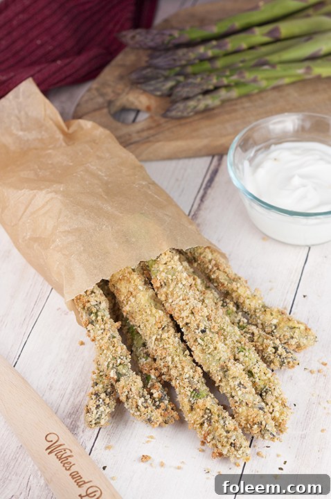 Simple Crispy Baked Parmesan Asparagus Fries with Creamy Lemon Dipping Sauce is a great recipe for a summer BBQ, summer side dish idea, healthy snack, or a picnic - you don't need to use your deep fryer with this recipe!
