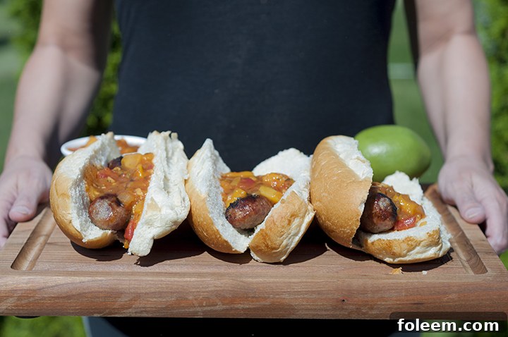 A delicious spread of Grilled Beer Brats with Mango Lime Salsa, ready for your next outdoor gathering.