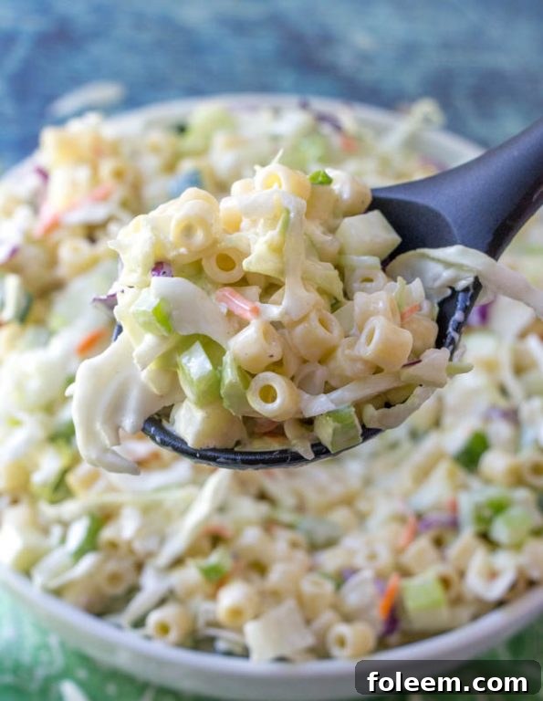 Creamy Macaroni Coleslaw Salad with fresh vegetables, pasta, and diced apple, perfect for summer potlucks and BBQs.