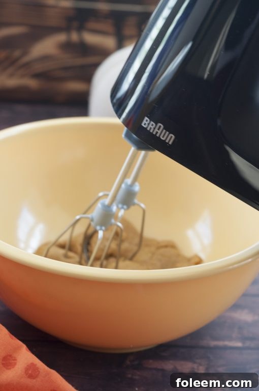 A Braun MultiMix Hand Mixer resting on a kitchen counter, ready for baking.