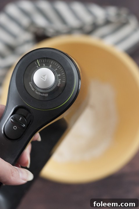 The Braun MultiMix 5 hand mixer in action, mixing cookie dough in a bowl.