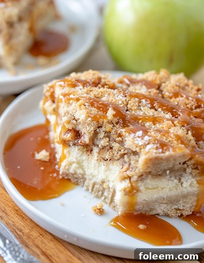 Quick & Easy Salted Caramel Apple Cheesecake Bars, featuring a golden shortbread crust, smooth cheesecake filling, cinnamon apples, crumbly streusel, and a salted caramel finish, ideal for festive occasions.