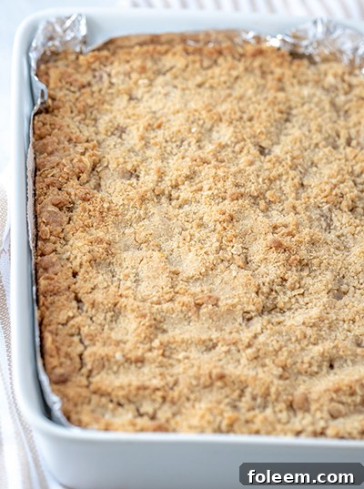 Delicious and Easy Salted Caramel Apple Cheesecake Bars with a shortbread base, creamy filling, spiced apples, streusel, and caramel, perfect for Thanksgiving or Christmas.