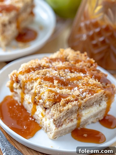 Simple Salted Caramel Apple Cheesecake Bars recipe with a crunchy shortbread crust, decadent cheesecake, flavorful apples, buttery streusel, and sweet-salty caramel, a holiday favorite.