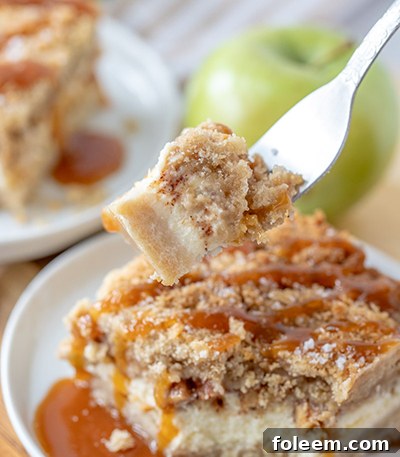 Homemade Salted Caramel Apple Cheesecake Bars with a buttery shortbread base, smooth cheesecake layer, spiced apples, crumbly streusel, and a generous salted caramel drizzle, perfect for autumn and holiday gatherings.