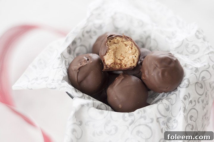 Easy No-Bake Peanut Butter Rice Krispie Balls: chocolate-dipped, crispy, and perfect for any holiday celebration.