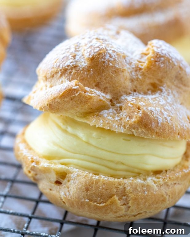 Close-up of a generously filled cream puff, ready to be eaten