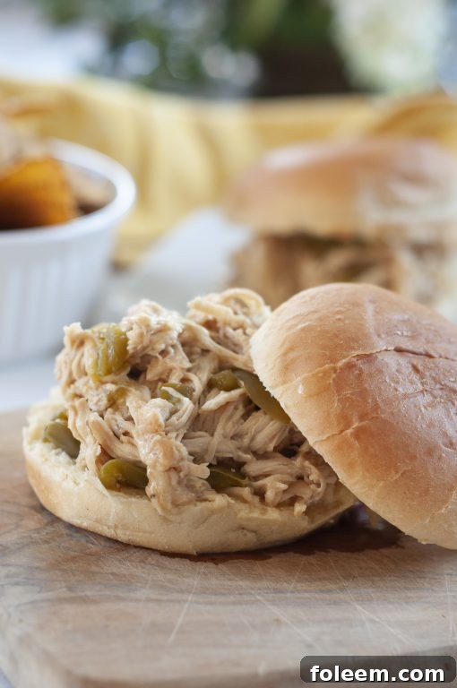 Delicious Slow Cooker Pulled Cheesesteak Chicken served on a bun, perfect for an easy family meal or party.