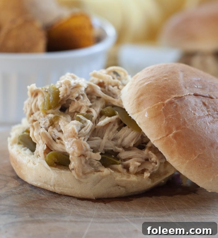 Close-up of Slow Cooker Pulled Cheesesteak Chicken, showcasing the tender chicken, peppers, onions, and melted cheese, ready for serving.