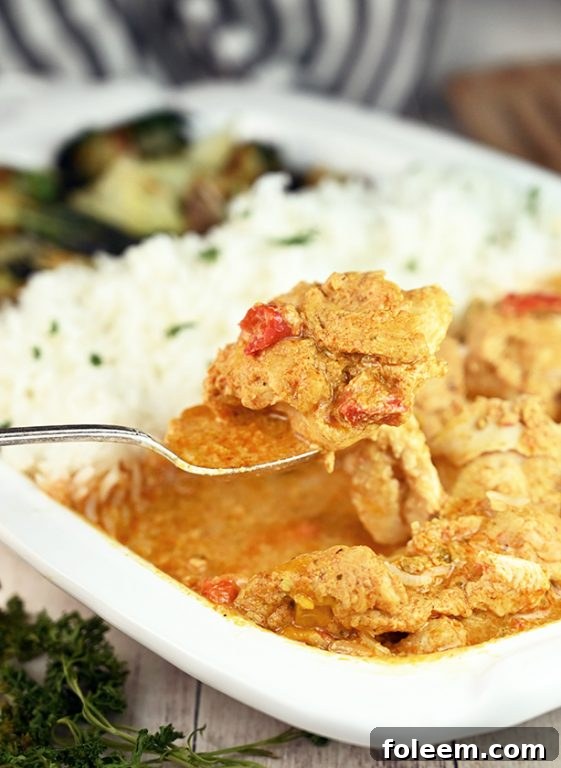 Boneless chicken thighs swimming in rich red curry and coconut milk sauce
