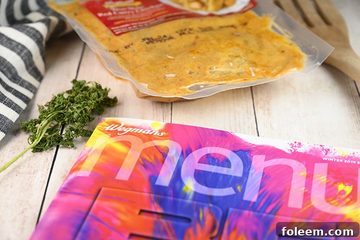 Wegmans Food You Feel Good About logo alongside the Thai Red Curry Chicken meal