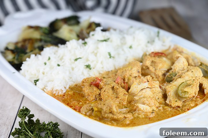 Thai Style Red Curry Chicken served with side dishes, showcasing a complete meal