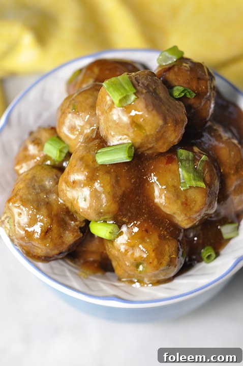 Baked Orange Meatballs ready to be tossed in a sweet Asian sauce, ideal for any crowd or potluck.