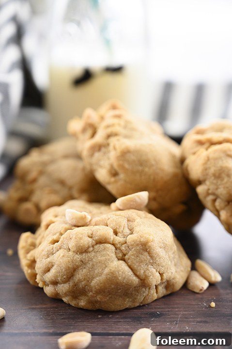 A stack of thick and chewy bakery-style double peanut butter cookies with a gooey center, the perfect treat for any peanut butter lover.