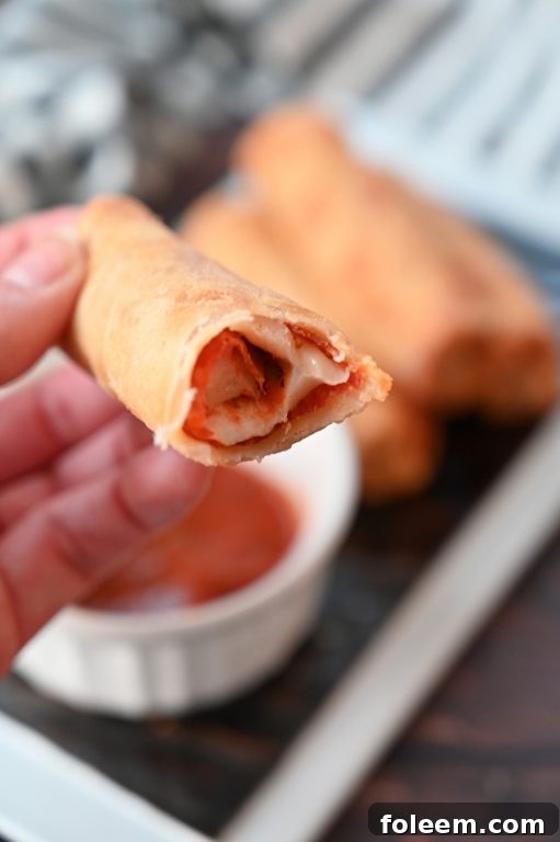 A close-up of the delicious filling inside a freshly baked pizza roll
