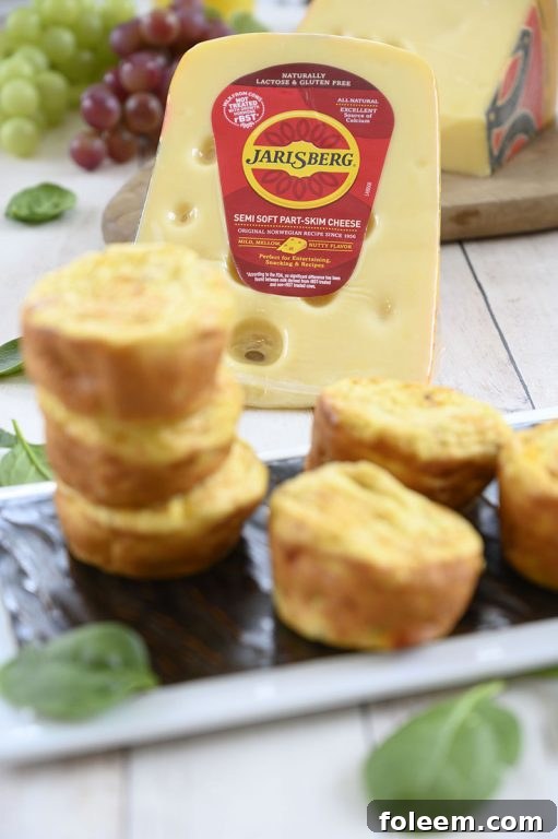 Freshly baked Mini Sausage, Spinach, and Jarlsberg Cheese Frittatas cooling, showcasing their golden-brown tops and rich texture