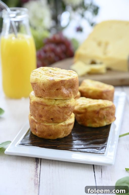 Four Mini Sausage, Spinach, and Jarlsberg Cheese Frittatas artfully arranged, ready for a delicious breakfast or brunch