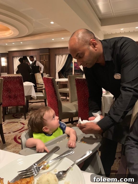 Fun waitstaff with the baby at the main dining room on board Royal Caribbean Symphony of the Seas cruise. 