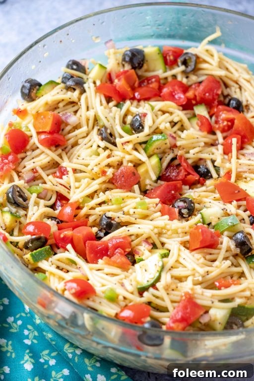 California Spaghetti Salad, an easy side dish with diverse textures, loaded with pasta and zucchini, perfect for summer potlucks and picnics.