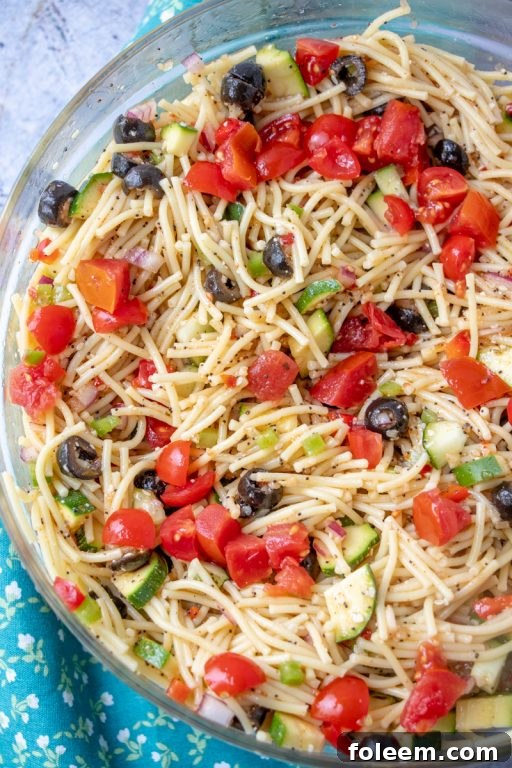Potluck or picnic easy side dish, California Spaghetti Salad with diverse textures and fresh ingredients, ideal for summer.