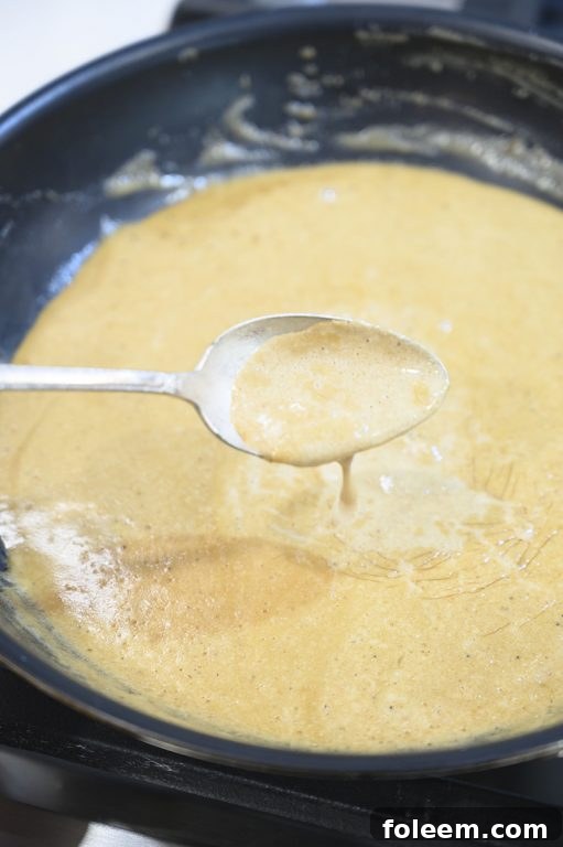A delectable bowl of creamy onion blue cheese dipping sauce, perfectly prepared to accompany grilled ribeye steaks.