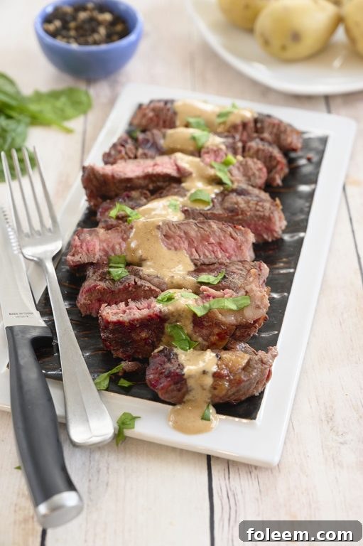 Delicious grilled ribeye steak with the rich onion blue cheese sauce, promising a simple yet elegant summer cookout experience.