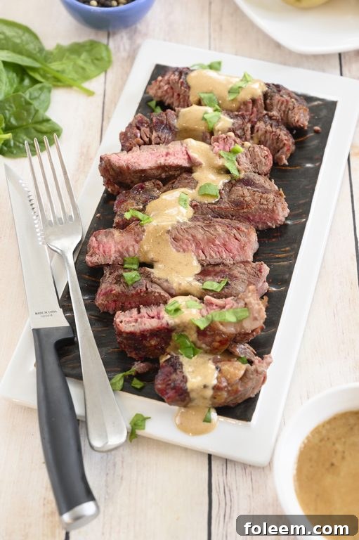 The ultimate grilled ribeye steak with a generous serving of onion blue cheese sauce, promising a delicious and easy summer meal without the high cost of a steakhouse.