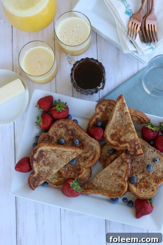 Overhead view of french toast with strawberries and blueberries.