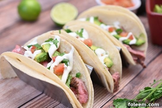 Tender, juicy Grilled Flank Steak Tacos with fresh avocado and vibrant Cilantro Lime Crema.